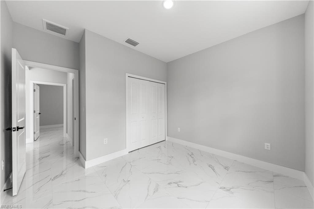 237 Columbus Boulevard South Lehigh Acres, FL 33974 - Photo 17 of 25 wooden floor in an empty room