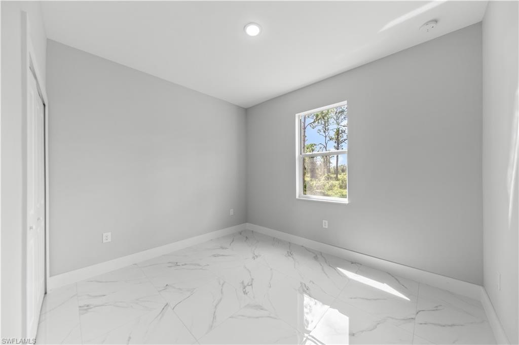 237 Columbus Boulevard South Lehigh Acres, FL 33974 - Photo 19 of 25 an empty room with a window