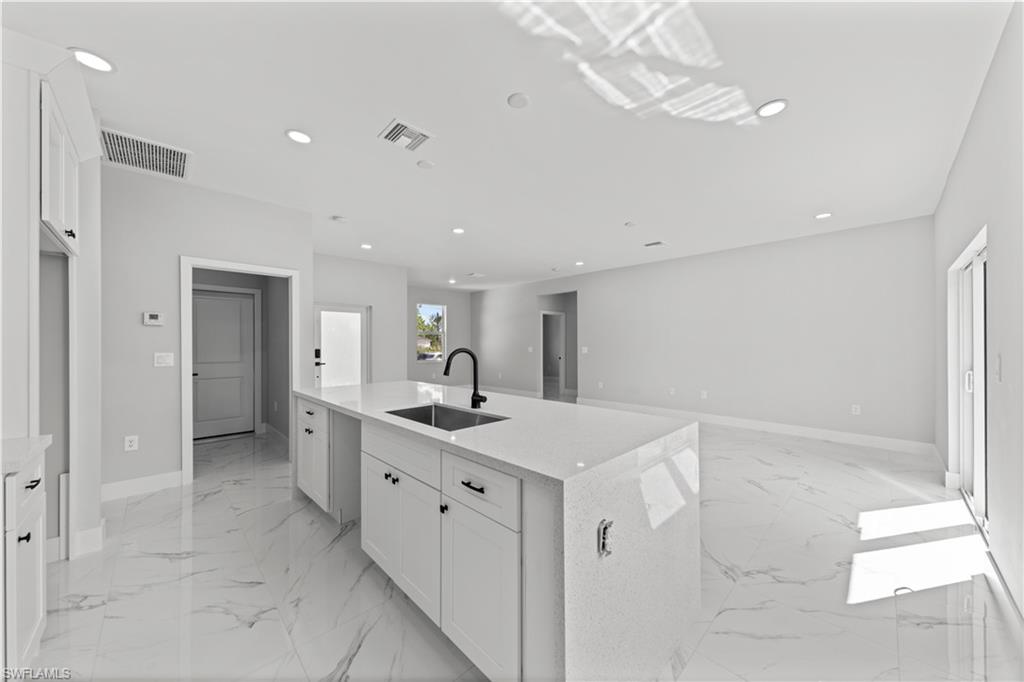 237 Columbus Boulevard South Lehigh Acres, FL 33974 - Photo 5 of 25 a view of a kitchen with a sink stainless steel appliances and cabinets