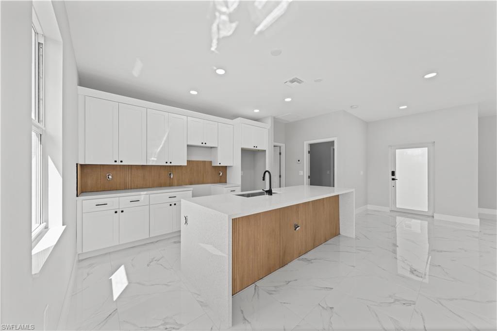 237 Columbus Boulevard South Lehigh Acres, FL 33974 - Photo 6 of 25 a kitchen with white cabinets appliances and sink