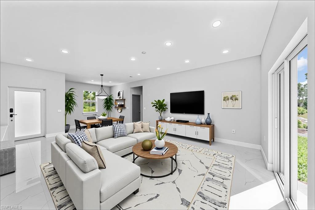 237 Columbus Boulevard South Lehigh Acres, FL 33974 - Photo 10 of 25 a living room with furniture and a flat screen tv