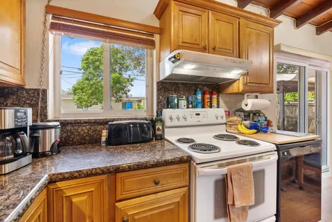 a kitchen that has a stove and a microwave