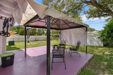 a view of a backyard with sitting area