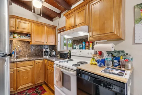 a kitchen with a sink cabinets and appliances