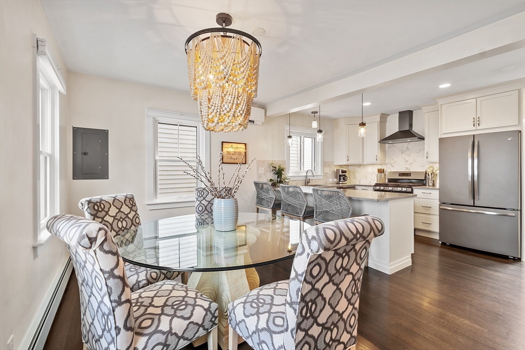 32 Maple Avenue Nahant, MA 01908 - Photo 14 of 37 a kitchen with stainless steel appliances granite countertop a dining table chairs and white cabinets