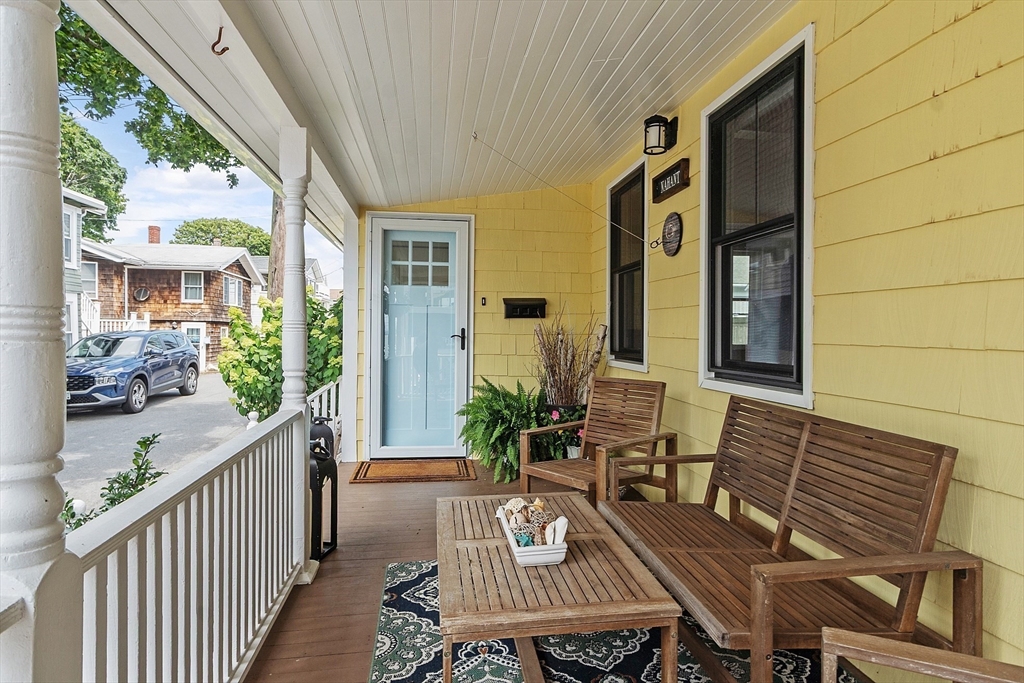 32 Maple Avenue Nahant, MA 01908 - Photo 3 of 37 a view of a patio with couches chairs potted plants and wooden floor