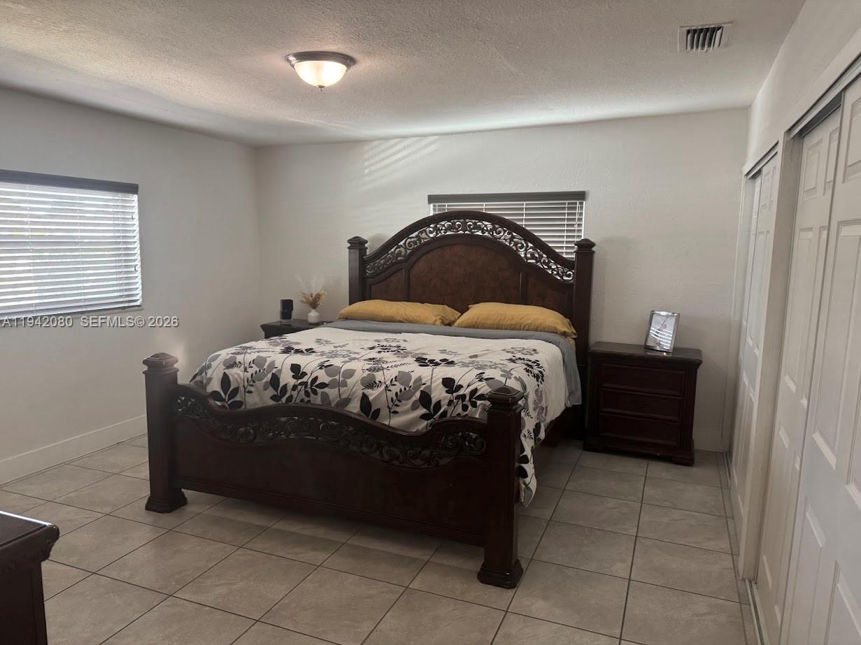 412 West 15th Street Hialeah, FL 33010 - Photo 15 of 48 a bedroom with a bed and a window
