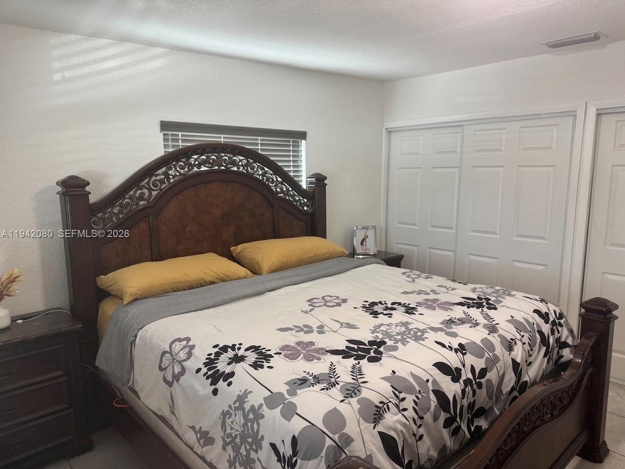412 West 15th Street Hialeah, FL 33010 - Photo 18 of 49 a bedroom with a bed and a mirror
