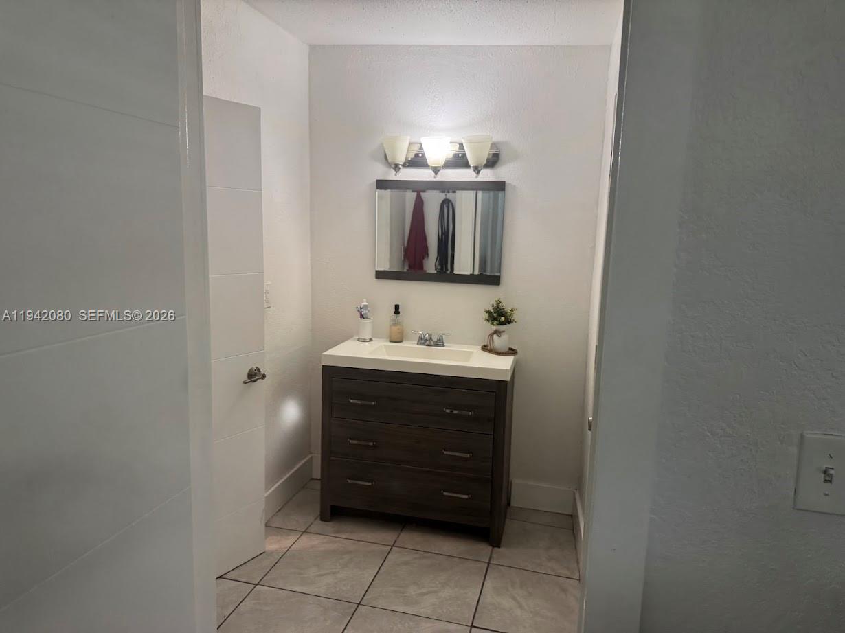 412 West 15th Street Hialeah, FL 33010 - Photo 20 of 49 a bathroom with a sink and a mirror