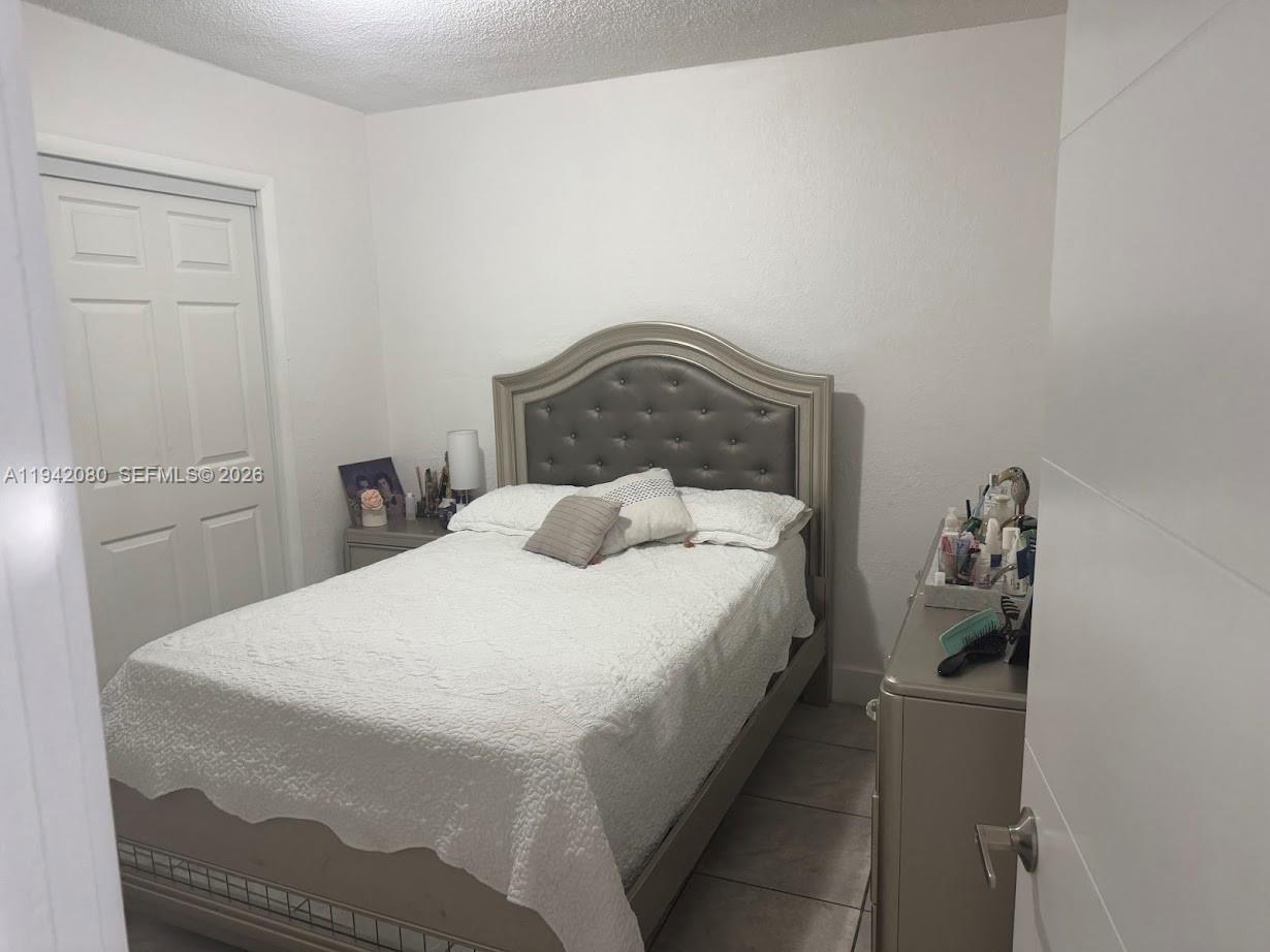 412 West 15th Street Hialeah, FL 33010 - Photo 25 of 48 a bedroom with a bed and lamp