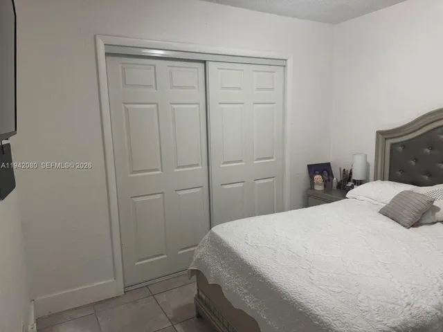 a large bed sitting in a bedroom next to a cabinet