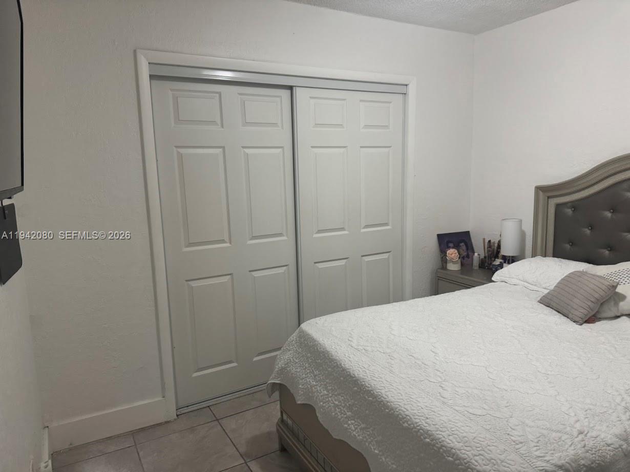 412 West 15th Street Hialeah, FL 33010 - Photo 27 of 49 a bedroom with a bed and a closet