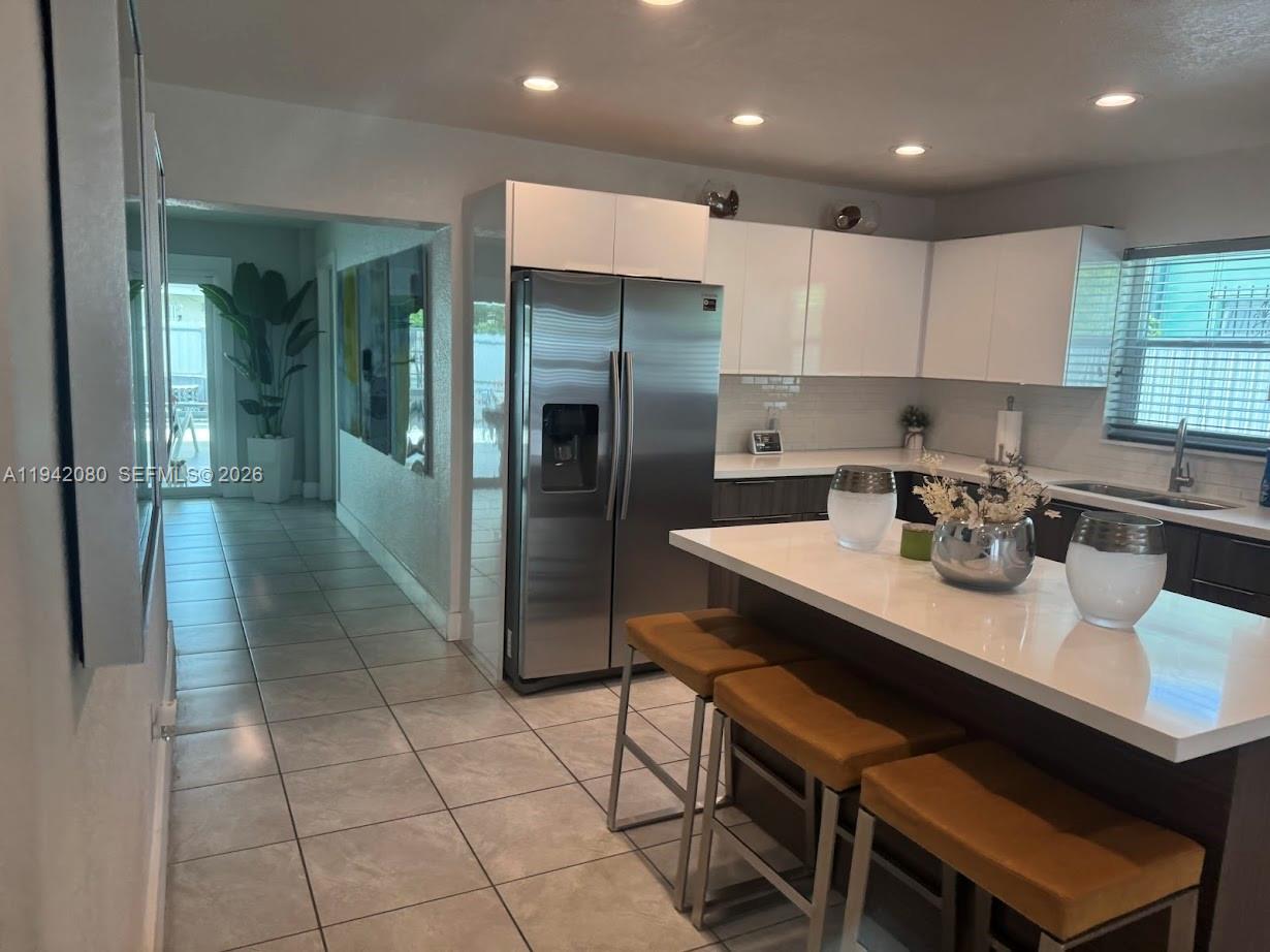 412 West 15th Street Hialeah, FL 33010 - Photo 29 of 49 a kitchen with a sink cabinets and stainless steel appliances