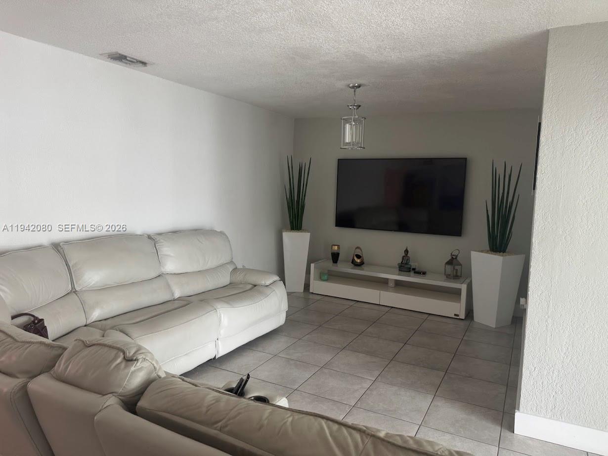 412 West 15th Street Hialeah, FL 33010 - Photo 29 of 48 a living room with furniture and a flat screen tv