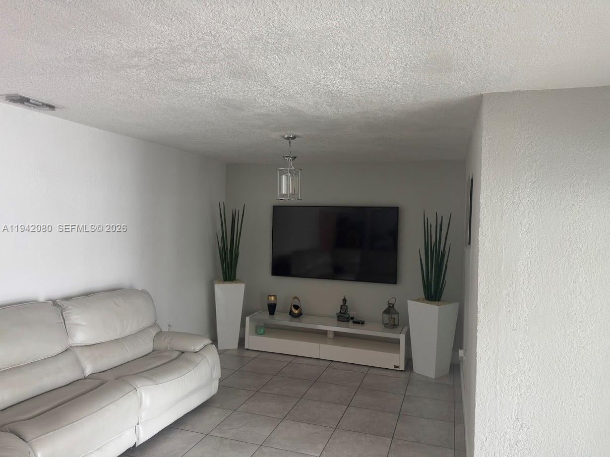 412 West 15th Street Hialeah, FL 33010 - Photo 31 of 49 a living room with furniture and a flat screen tv