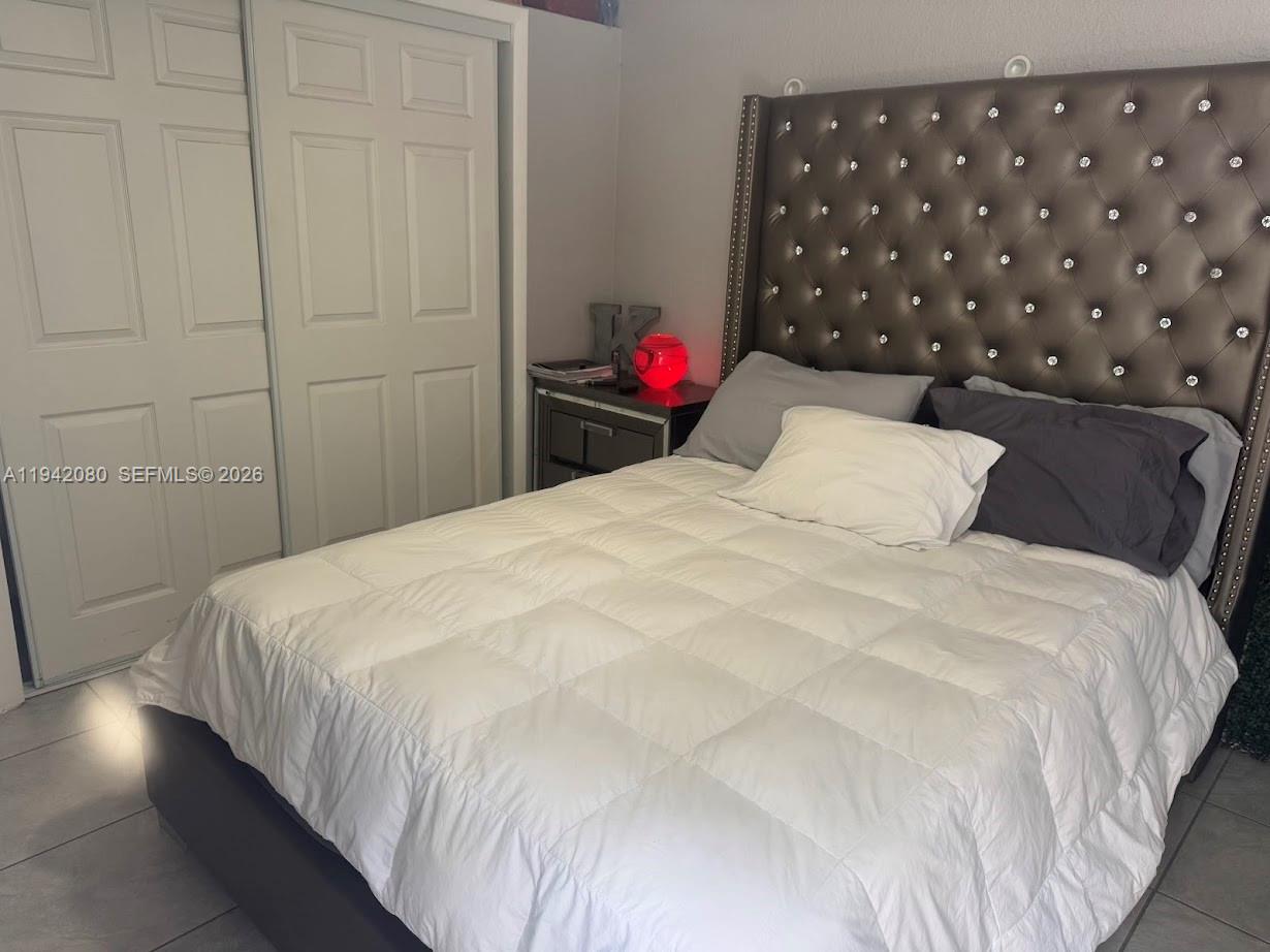 412 West 15th Street Hialeah, FL 33010 - Photo 34 of 49 a large bed sitting in a bedroom next to a cabinet