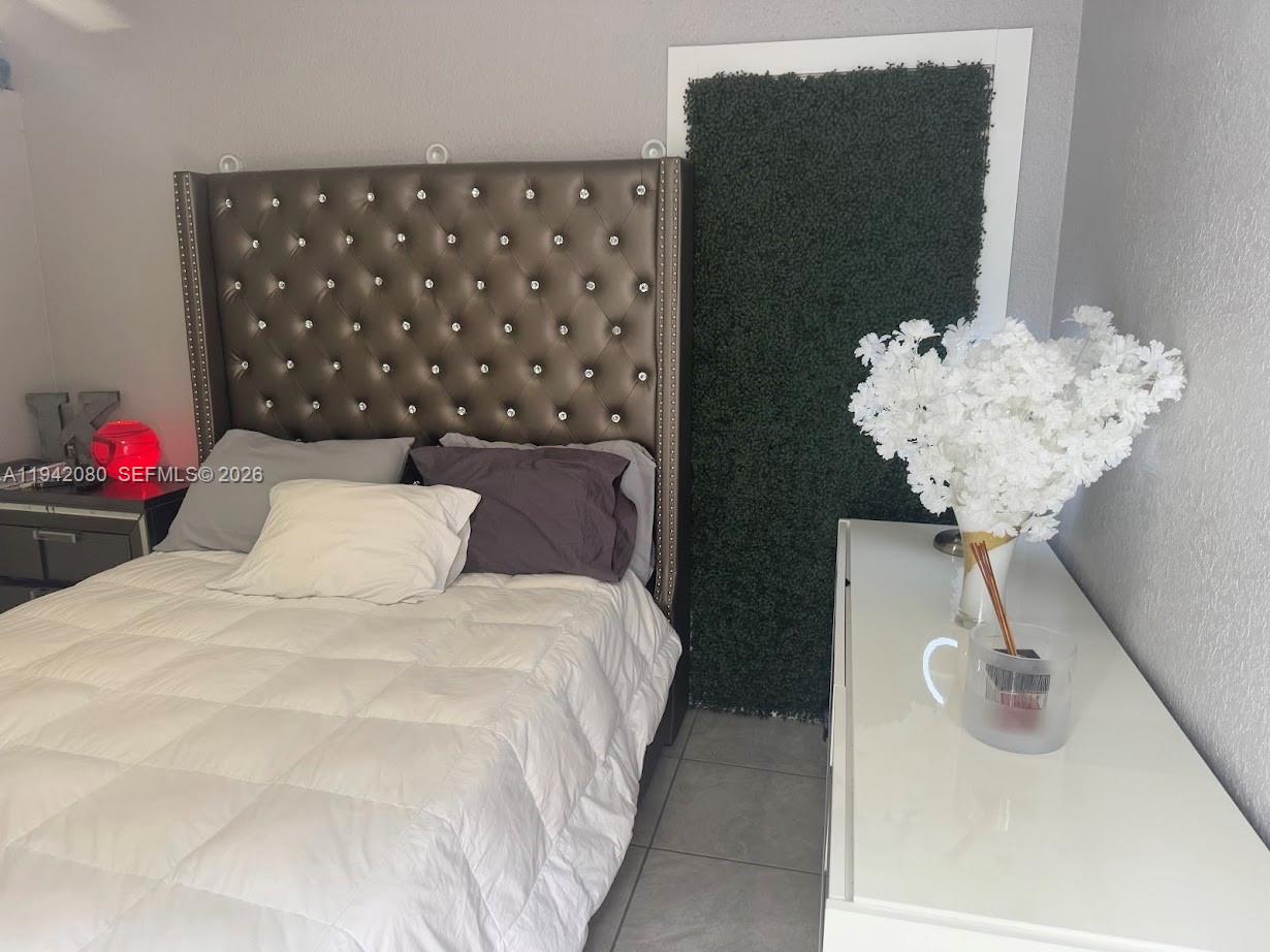 412 West 15th Street Hialeah, FL 33010 - Photo 34 of 48 a bedroom with a bed and a chandelier