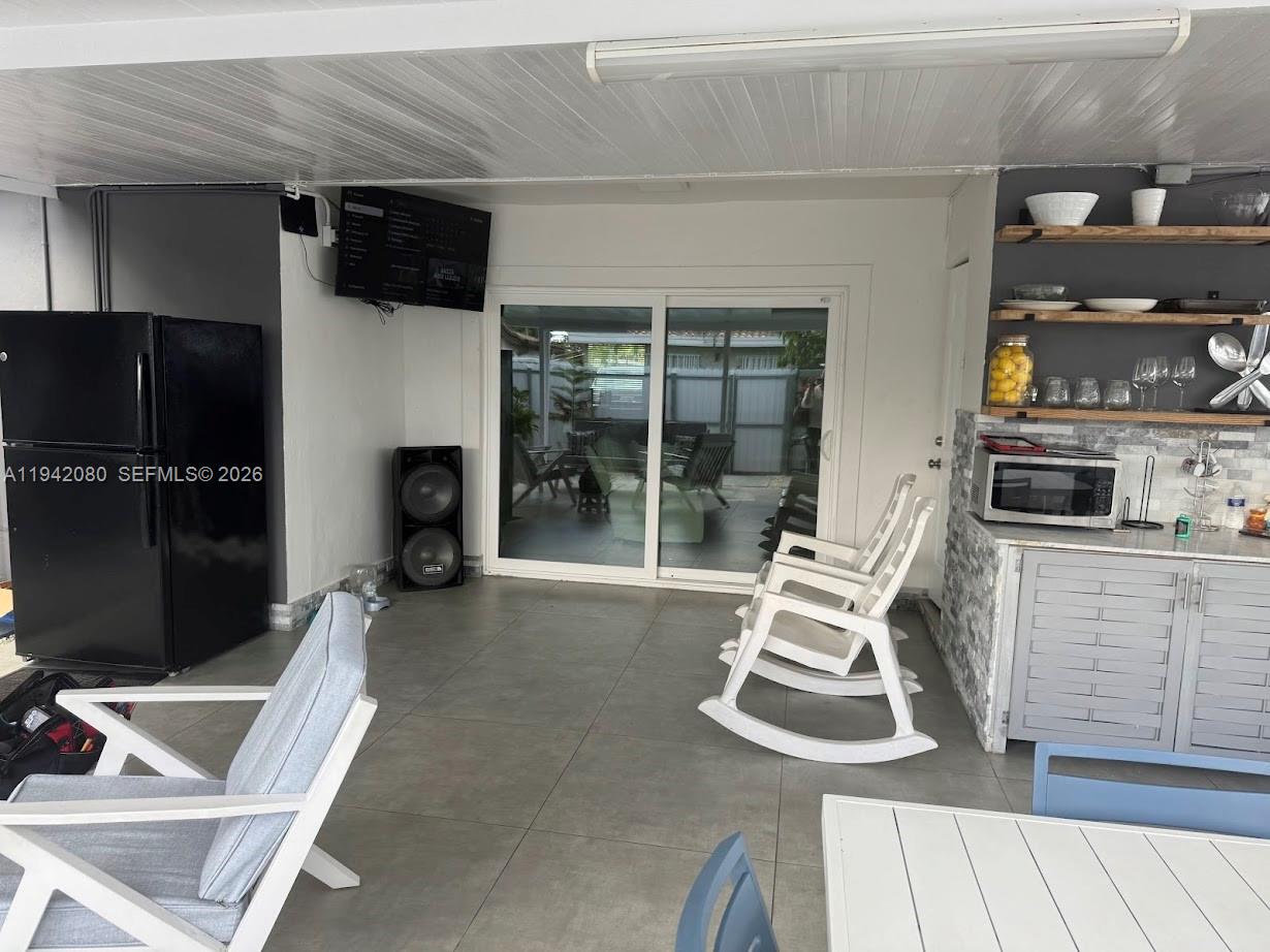 412 West 15th Street Hialeah, FL 33010 - Photo 47 of 48 a living room with furniture and a flat screen tv