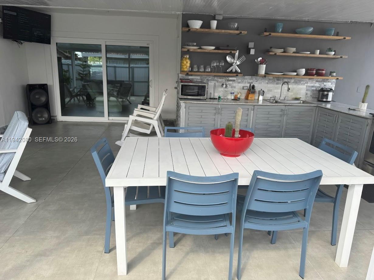 412 West 15th Street Hialeah, FL 33010 - Photo 47 of 49 a dining table with chairs and a view of kitchen