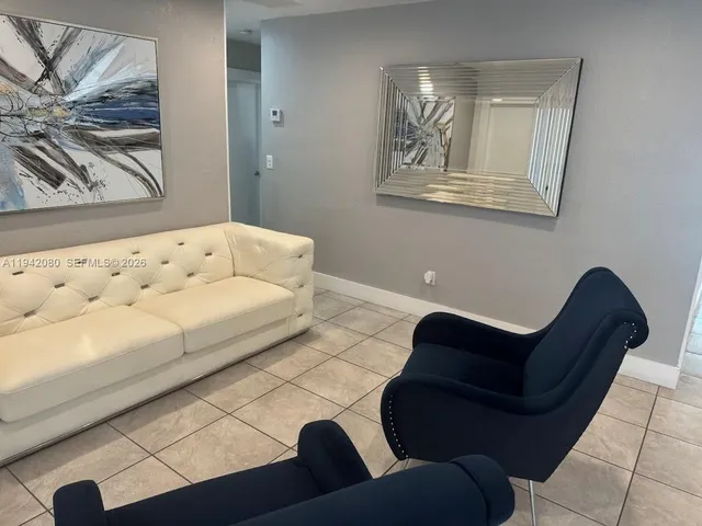 a kitchen with a table chairs and a microwave