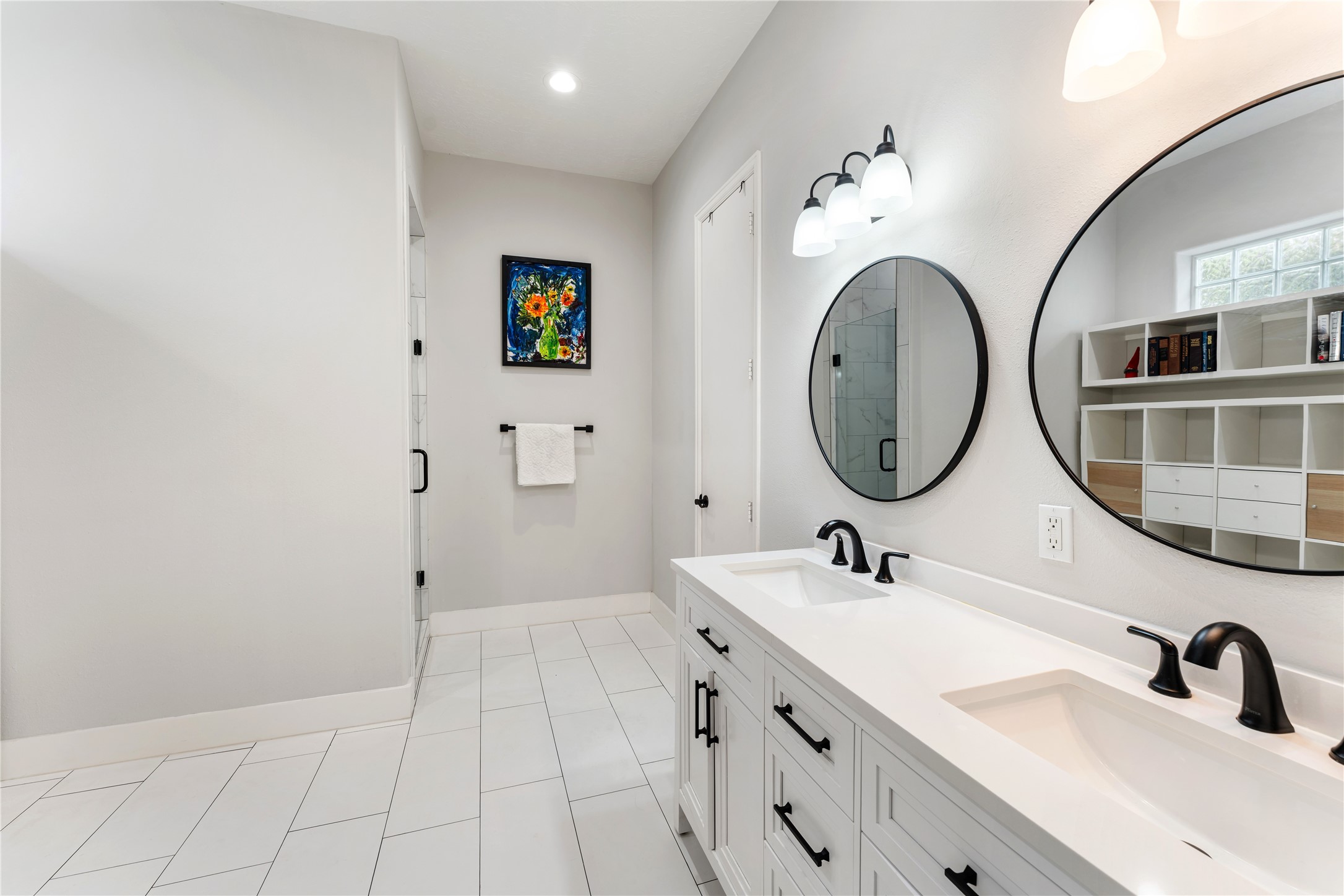 415 West 8th Street Houston, TX 77007 - Photo 11 of 39 Sophisticated finishes define this beautifully updated primary bath, where quartz countertops, dual sinks, and custom cabinetry create an elegant setting. Crisp neutral tones and designer accents offer timeless appeal that complements any style. The result is a luxurious space that feels polished, serene, and effortlessly functional.