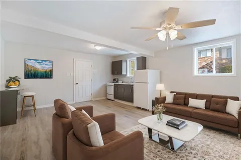 a living room with furniture a dining table and a fireplace