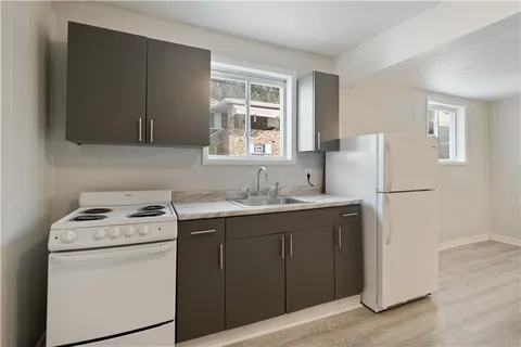 a utility room with sink dryer and washer