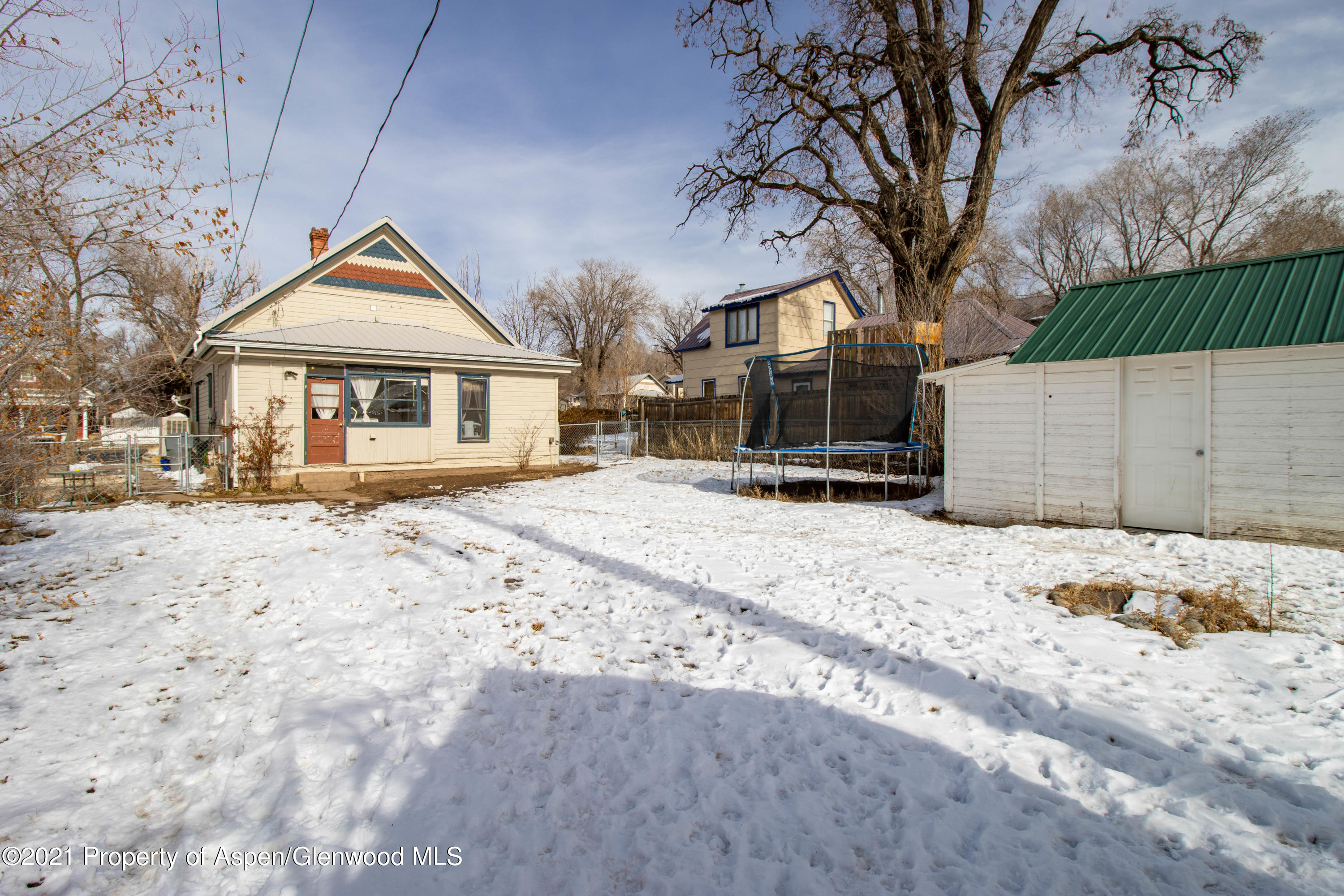 211 East 2nd Street Rifle, CO 81650 - Photo 11 of 15 a front view of a house with a yard covered in snow