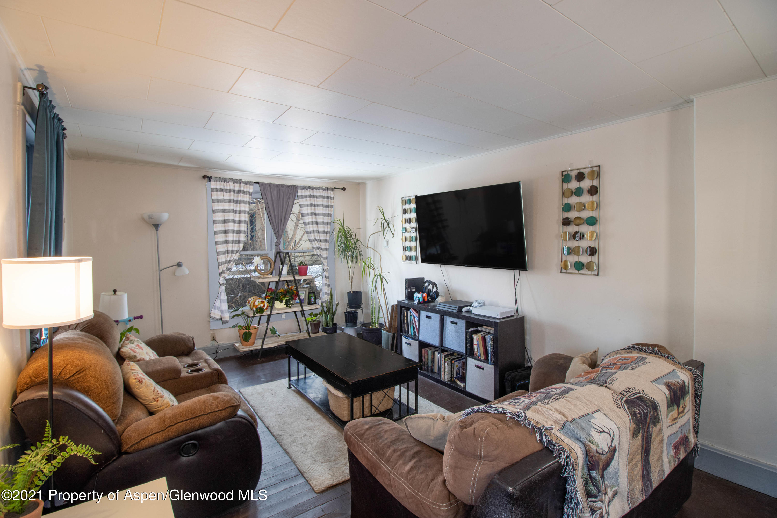 211 East 2nd Street Rifle, CO 81650 - Photo 3 of 15 a living room with furniture and a flat screen tv