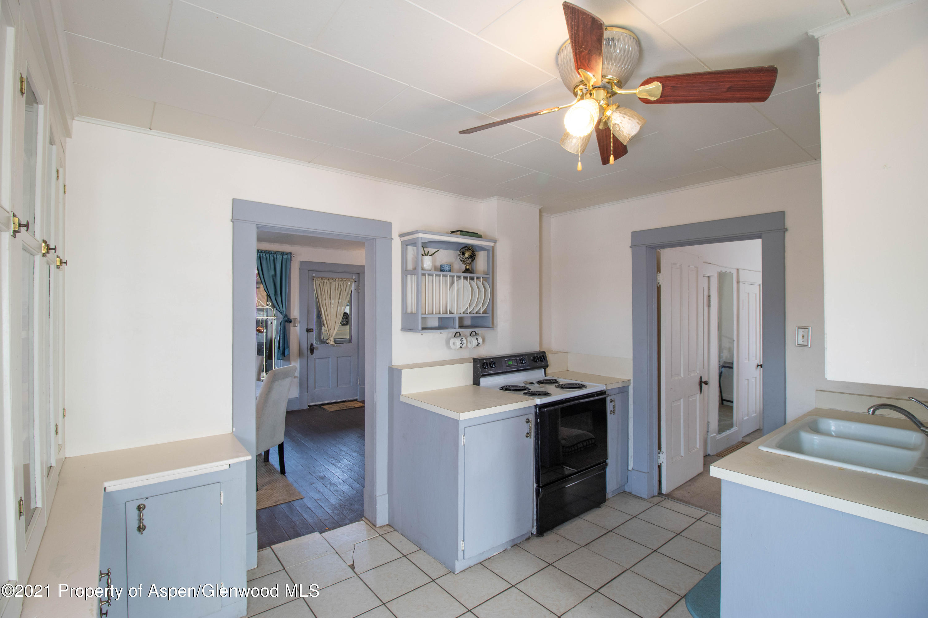 211 East 2nd Street Rifle, CO 81650 - Photo 5 of 15 a kitchen with a stove cabinets and a refrigerator