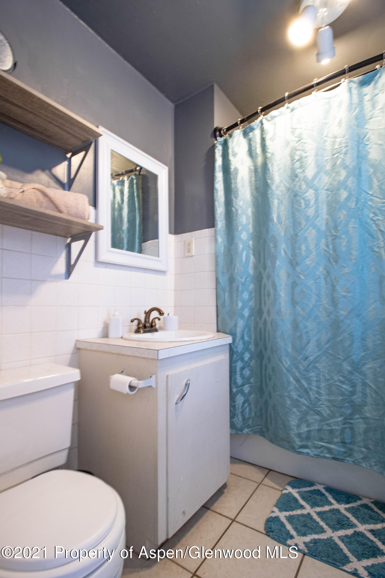 211 East 2nd Street Rifle, CO 81650 - Photo 8 of 15 a bathroom with a toilet a sink and a window