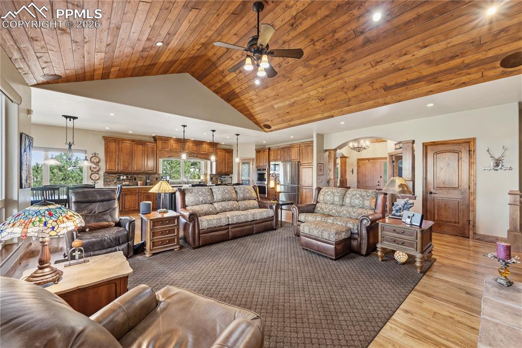 18890 Wing Tip Road Colorado Springs, CO 80908 - Photo 13 of 48 a living room with furniture and a chandelier