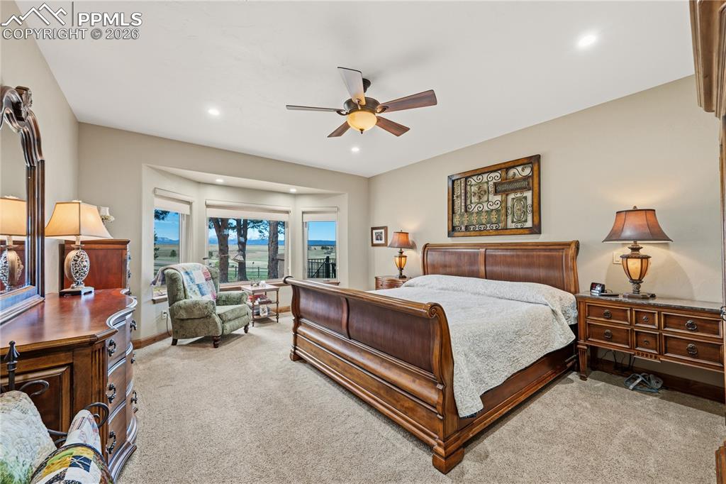18890 Wing Tip Road Colorado Springs, CO 80908 - Photo 16 of 48 a bedroom with a bed couch and a window