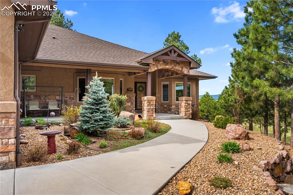 18890 Wing Tip Road Colorado Springs, CO 80908 - Photo 2 of 48 a front view of a house with a yard