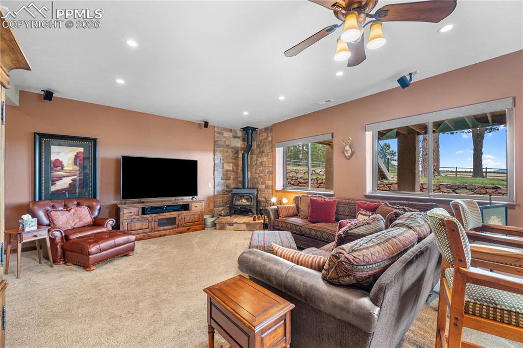 18890 Wing Tip Road Colorado Springs, CO 80908 - Photo 24 of 48 a living room with furniture and a flat screen tv