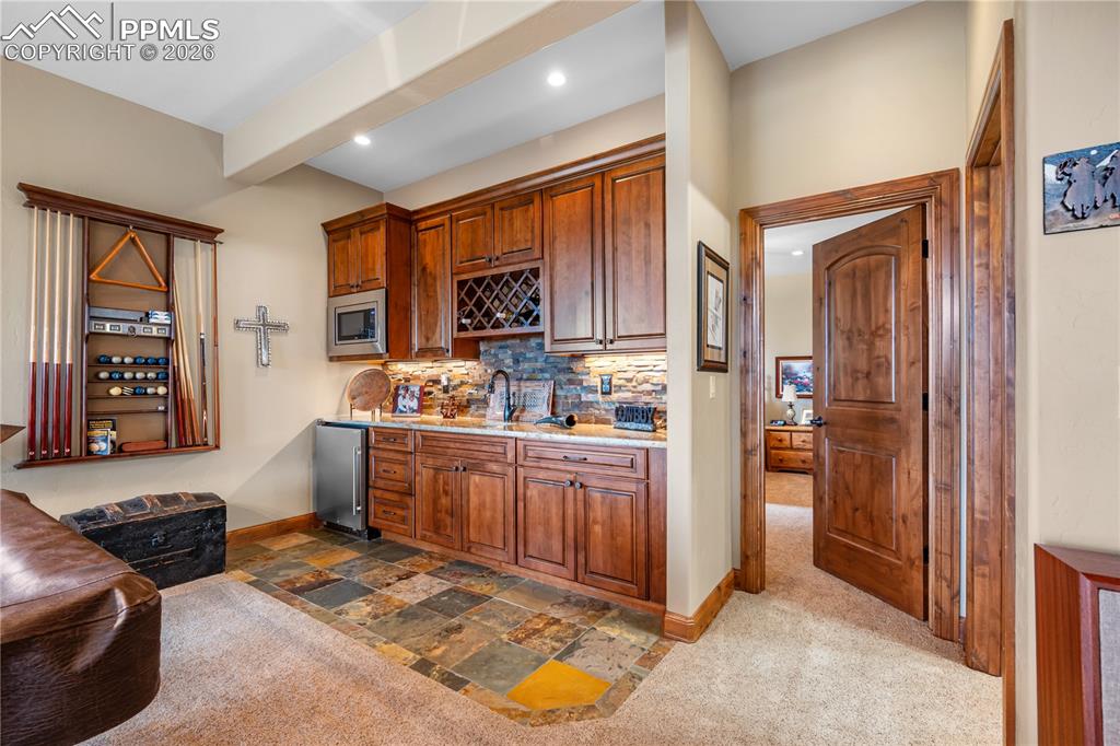18890 Wing Tip Road Colorado Springs, CO 80908 - Photo 27 of 48 a kitchen with stainless steel appliances granite countertop a refrigerator and a stove top oven