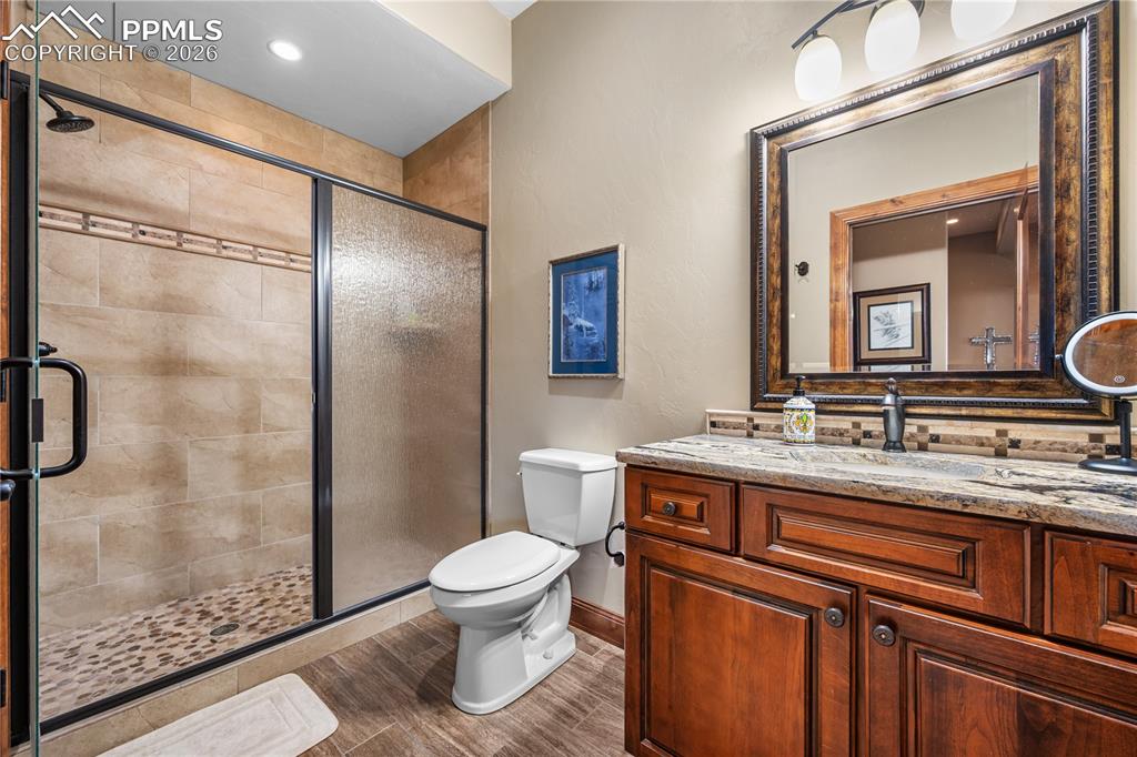 18890 Wing Tip Road Colorado Springs, CO 80908 - Photo 30 of 48 a bathroom with a sink a toilet and shower