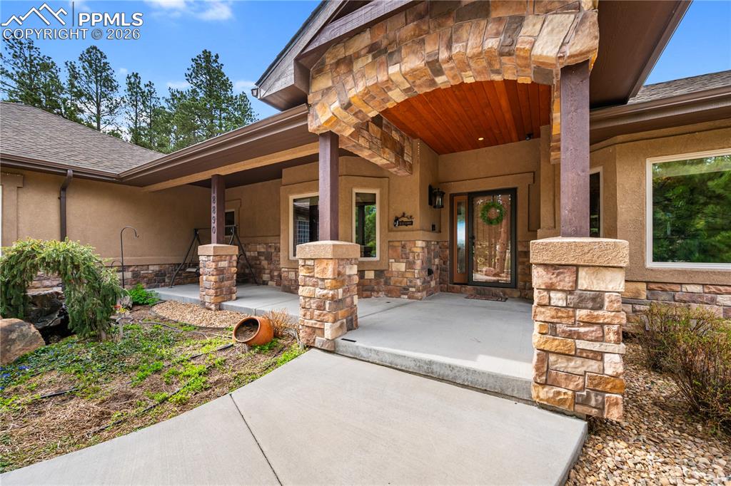 18890 Wing Tip Road Colorado Springs, CO 80908 - Photo 3 of 48 a front view of a house with garden