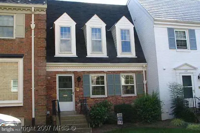 a view of a brick house with windows and yard