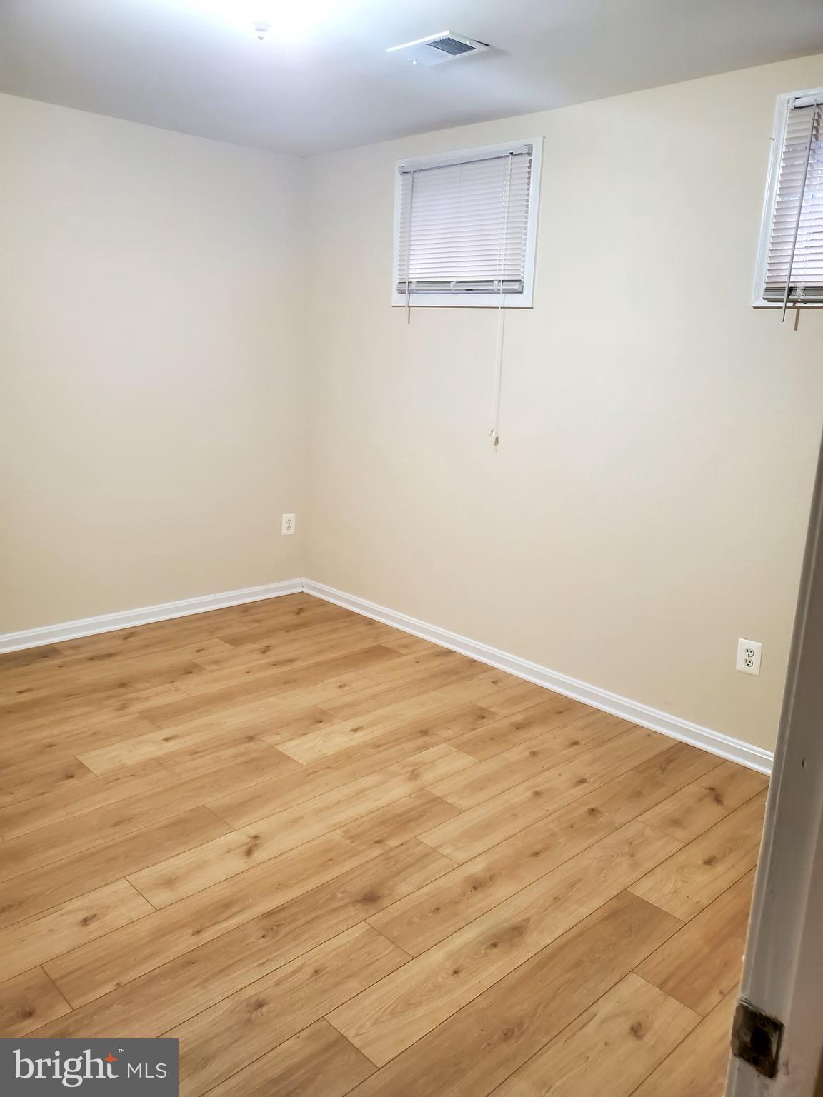 6735 Towne Lane Road McLean, VA 22101 - Photo 21 of 24 an empty room with wooden floor and windows