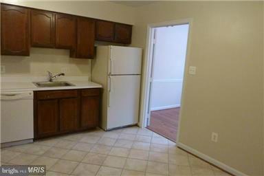 6735 Towne Lane Road McLean, VA 22101 - Photo 9 of 24 a kitchen with a refrigerator and a sink