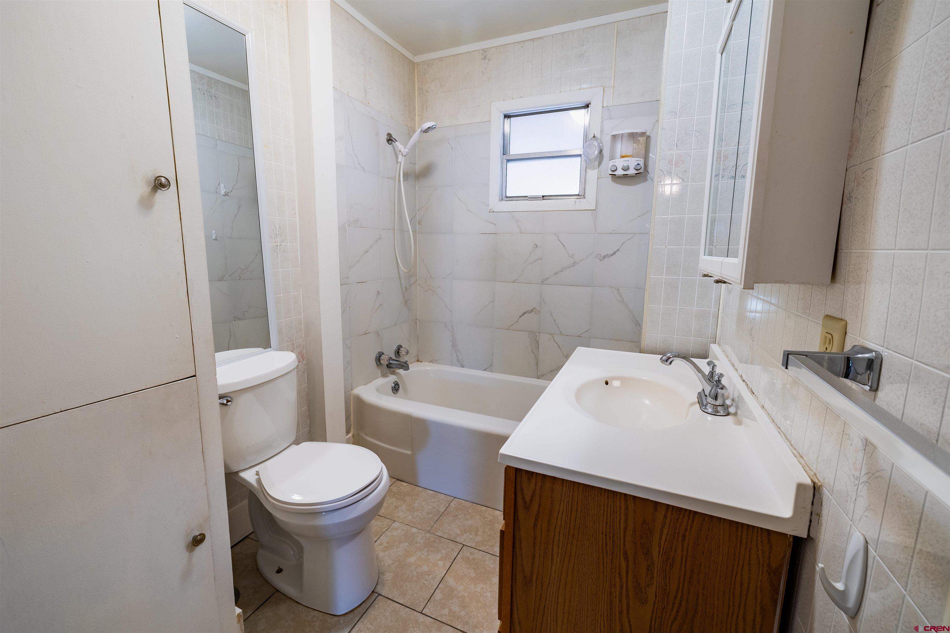 1015 Howard Street Delta, CO 81416 - Photo 11 of 22 a bathroom with a sink a toilet and shower