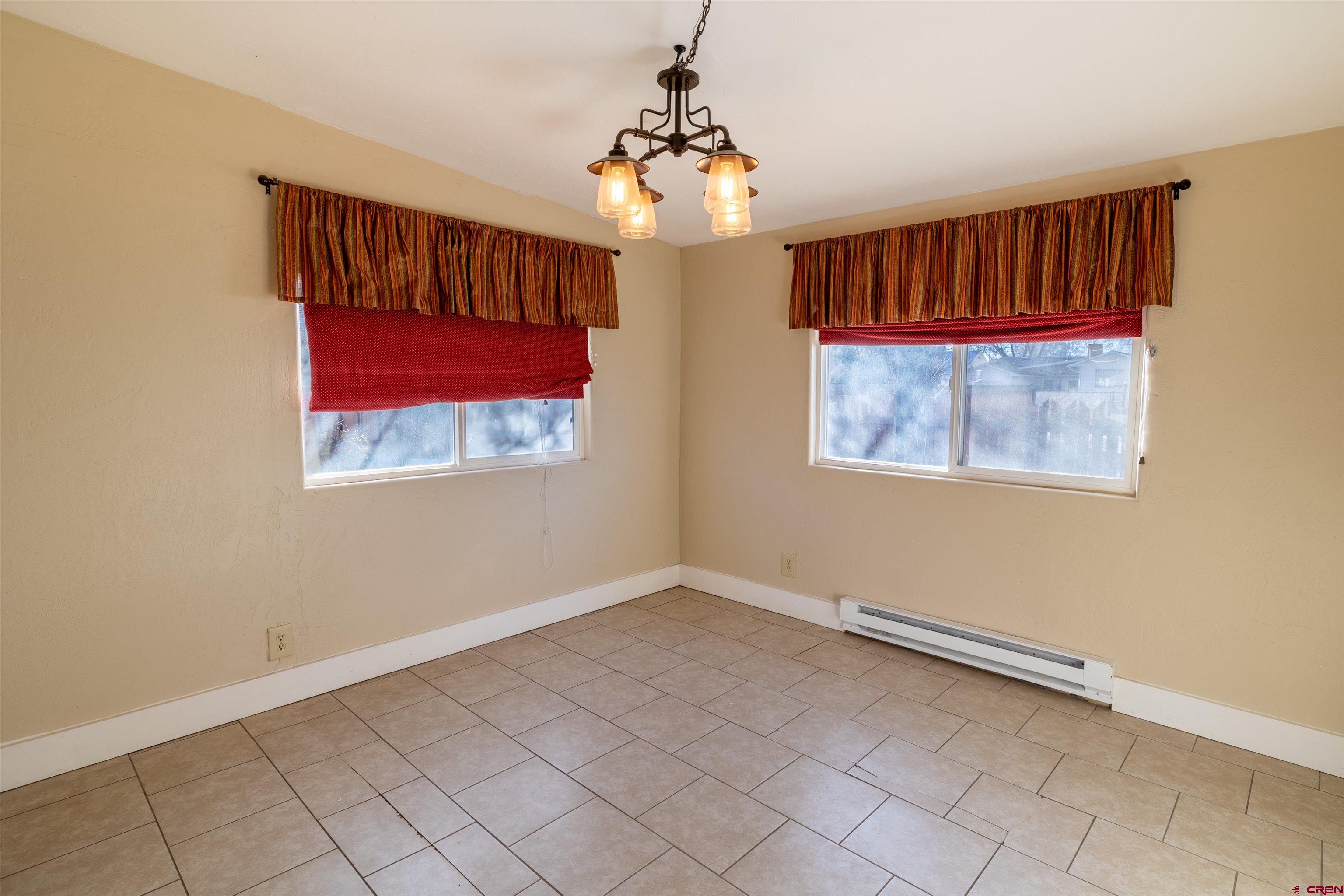 1015 Howard Street Delta, CO 81416 - Photo 8 of 22 an empty room with windows and fan