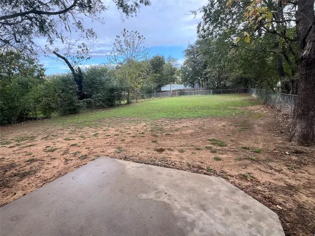 a view of a park with large trees