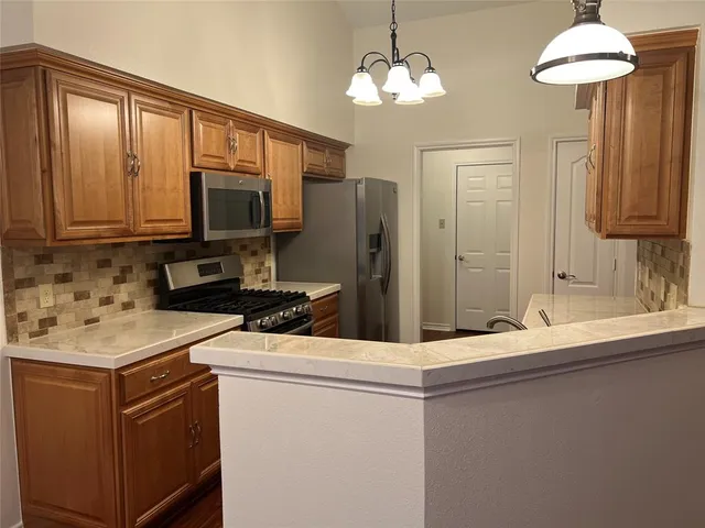 a kitchen with stainless steel appliances granite countertop a sink and a microwave