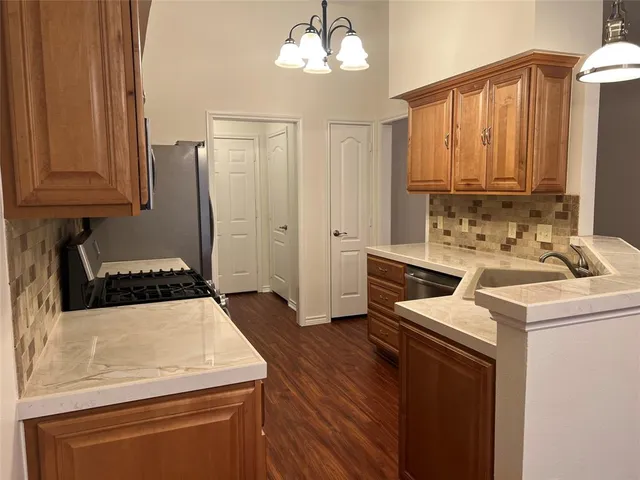 a kitchen with a stove a sink and a refrigerator