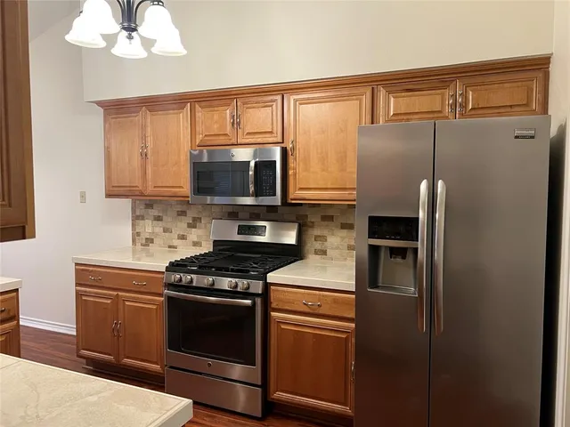 a kitchen with a refrigerator stove and microwave