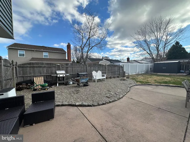 a living room with lots of furniture and a potted plant