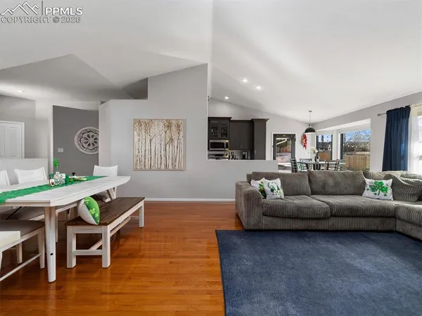 a living room with furniture wooden floor and a flat screen tv