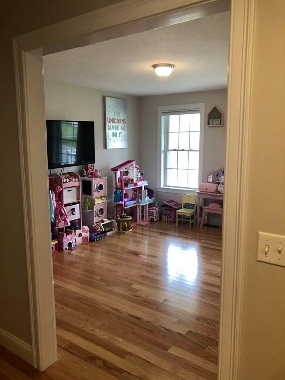 84 Old Pasture Road Dracut, MA 01826 - Photo 11 of 37 a living room with furniture and a flat screen tv